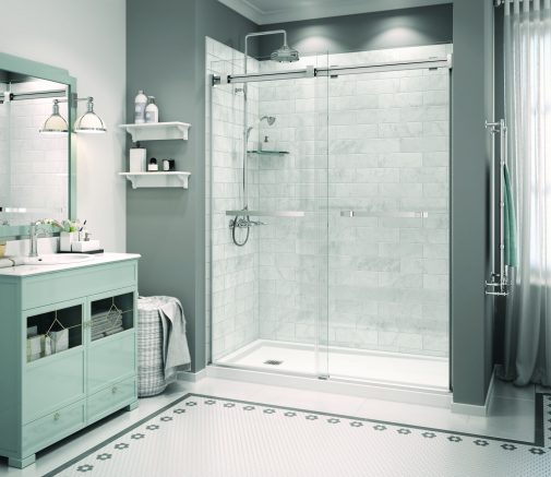 Very modern bathroom with large glass shower with marble tiling, a mint green vanity, white wall shelves, and floral floor tiling with black flowers